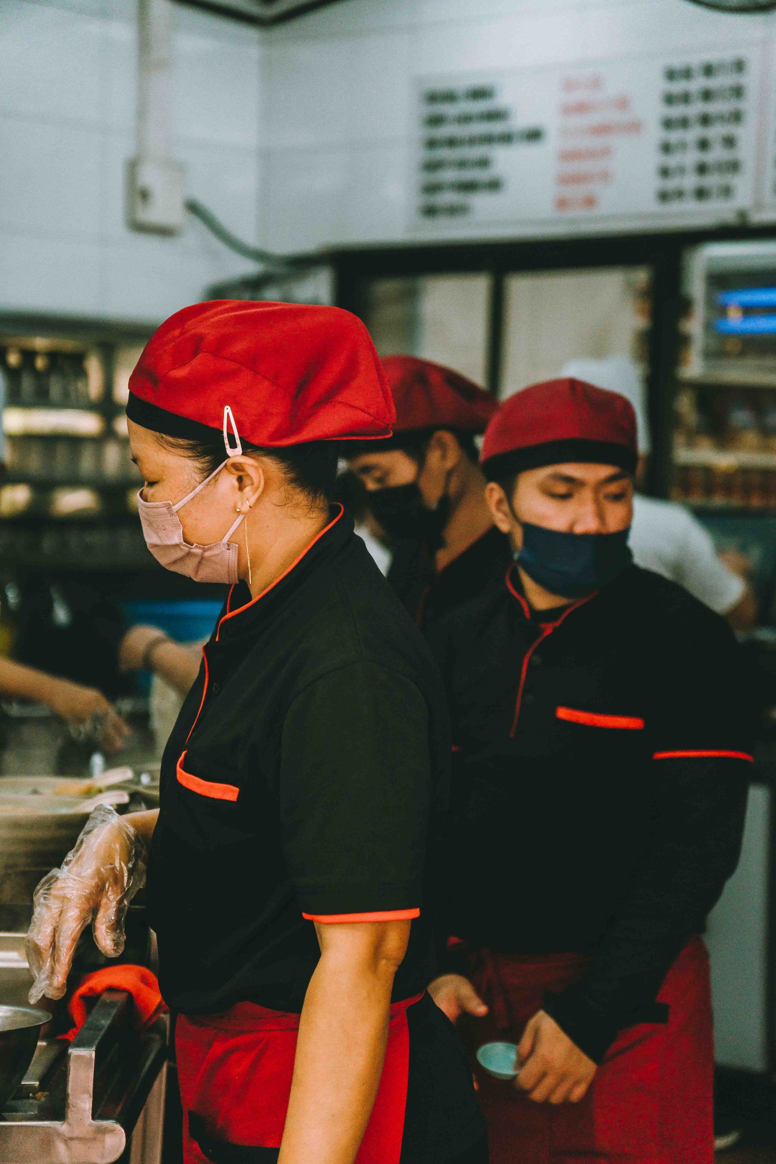 Restaurant employees preparing food in an active professional kitchen