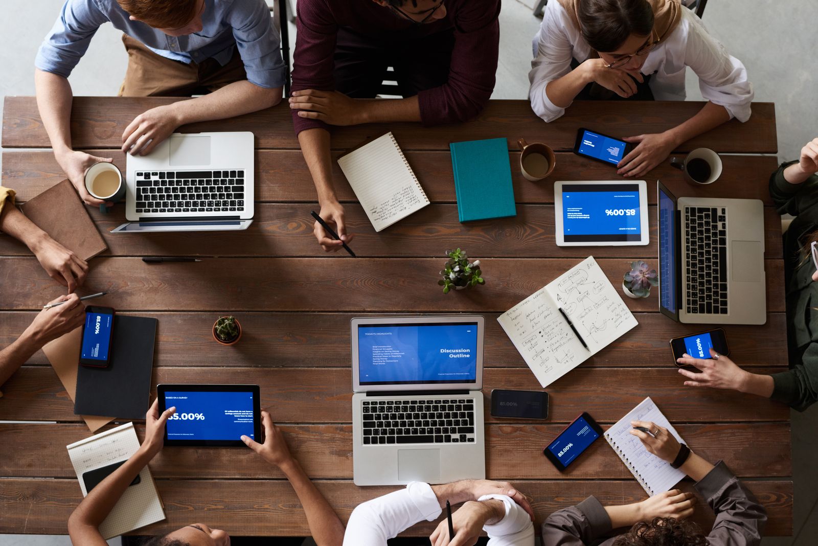 A working session around a table with laptops and notes