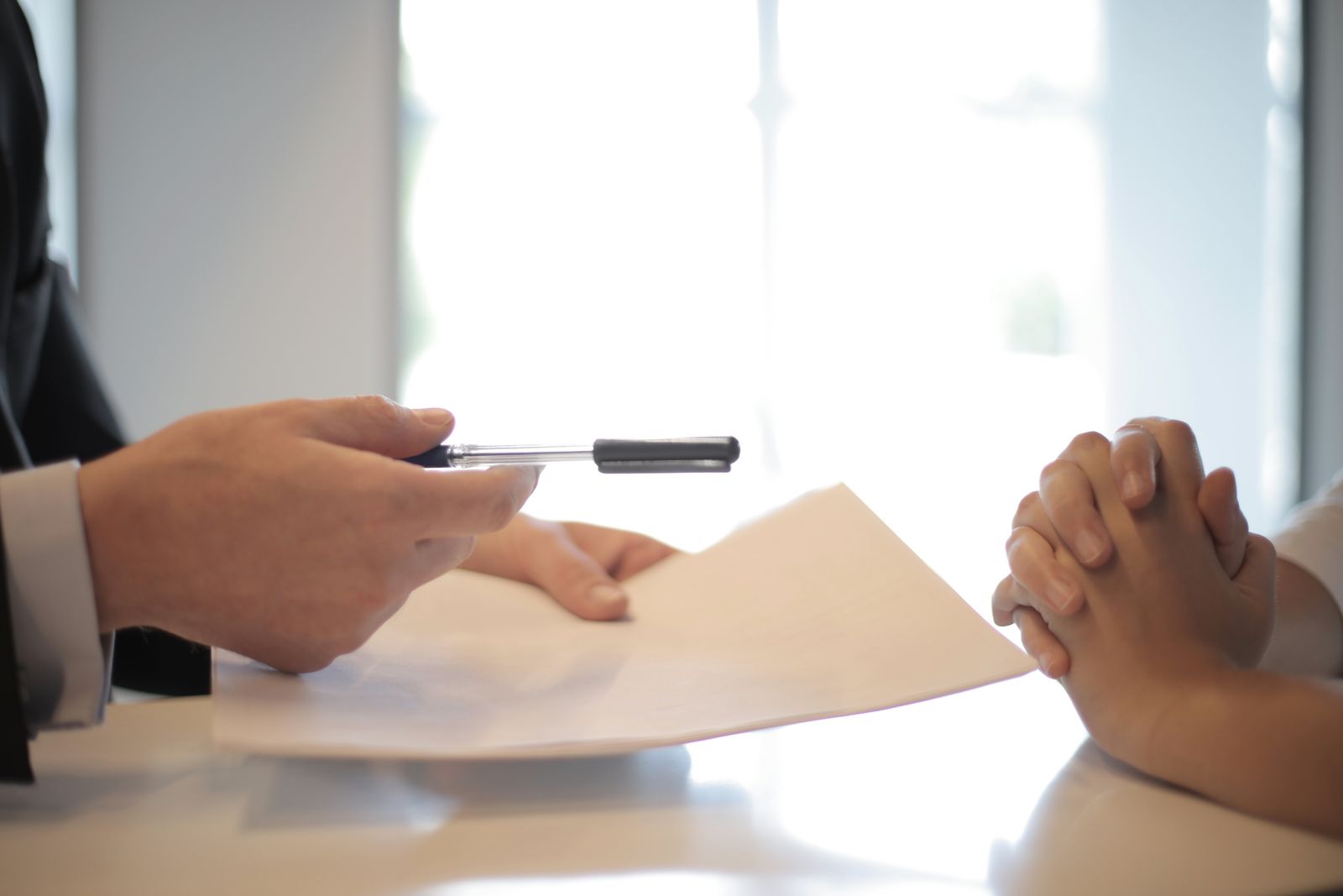 Documents being passed across a desk